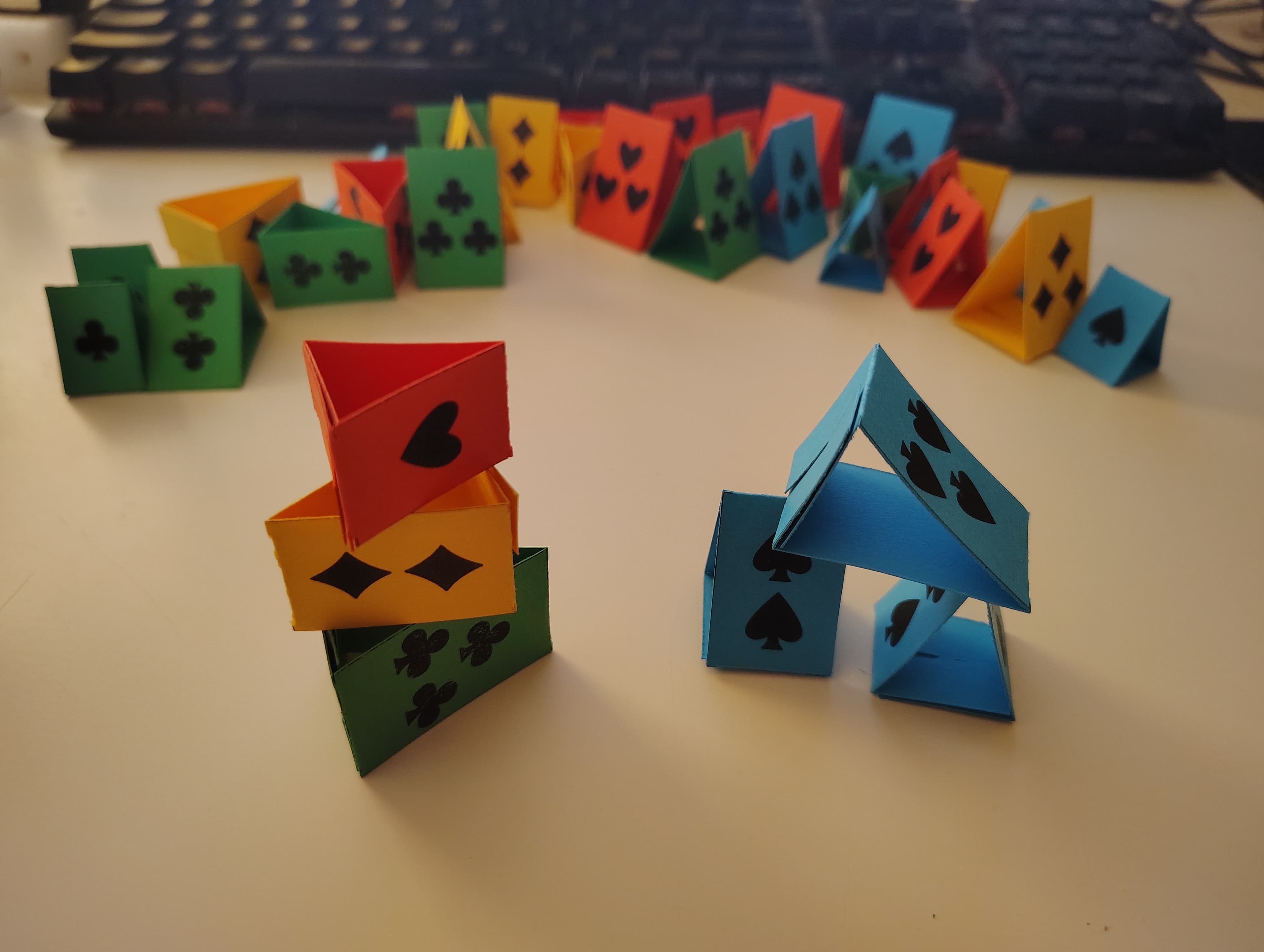 a pile of hollow "wedge" shapes made of red, yellow, green, and blue cardstock